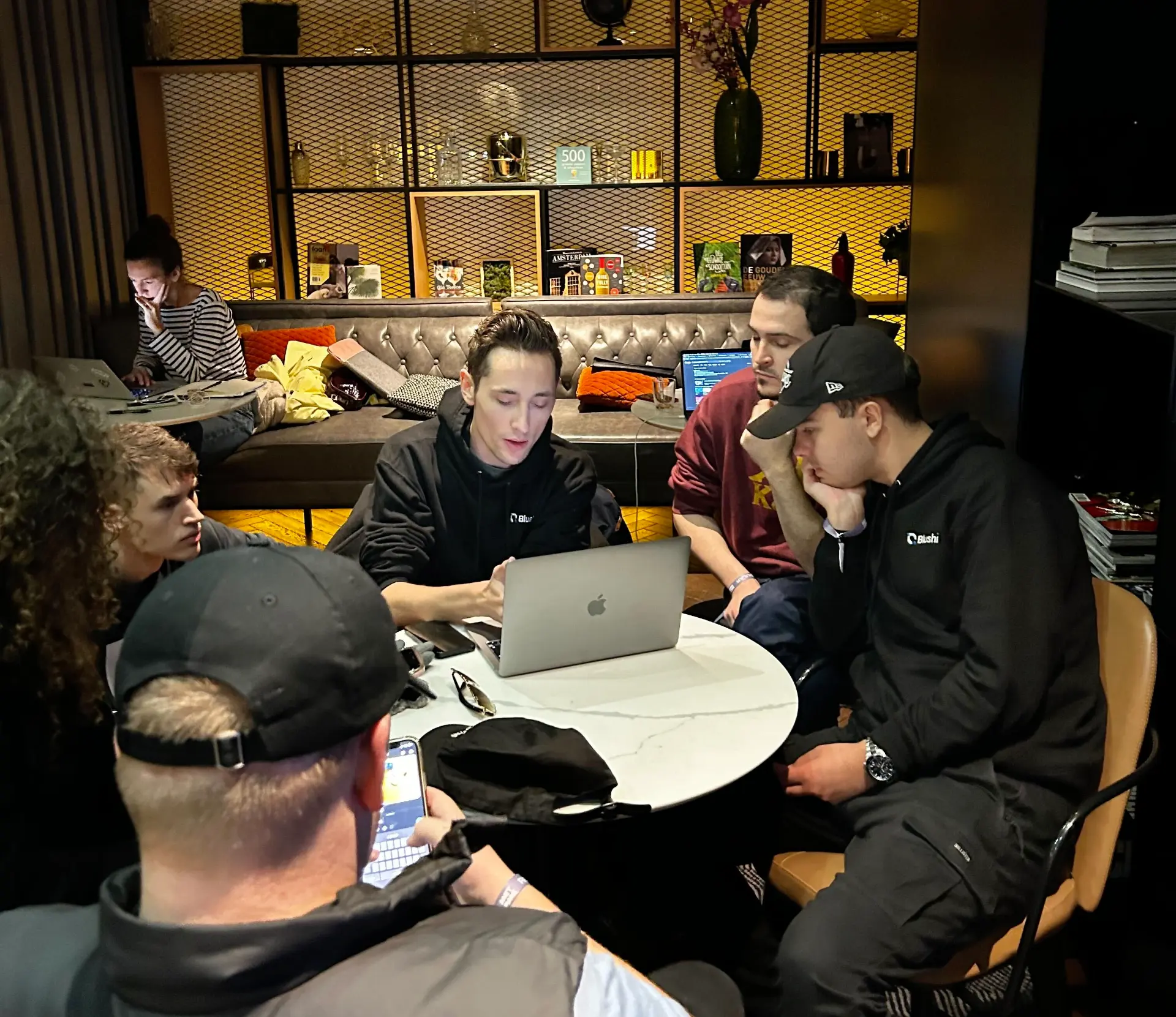 Chris Hartsook working through a project with a small group huddled around a laptop